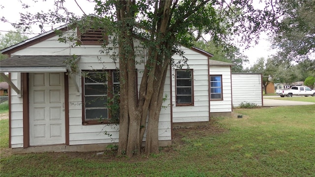 view of side of home featuring a yard