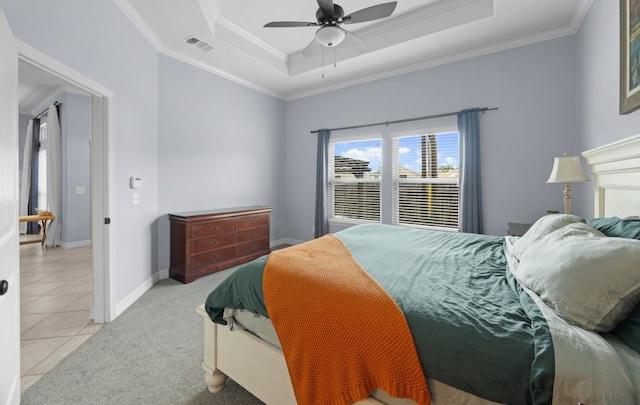 tiled bedroom featuring ceiling fan, ornamental molding, and a raised ceiling