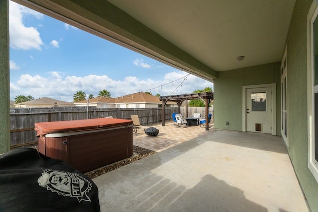 view of patio with a hot tub and a pergola