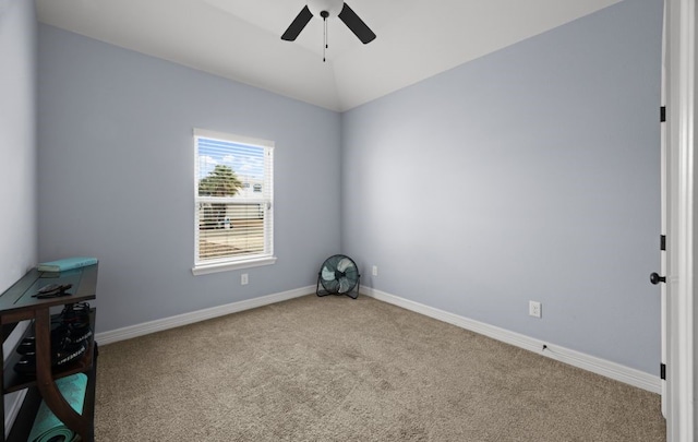 empty room with ceiling fan, lofted ceiling, and light colored carpet