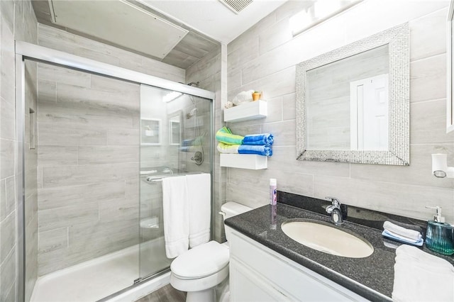 123 E Cora Lee Dr Unit 301, South Padre Island, TX 78597 - full bathroom featuring tile walls, toilet, vanity, and a shower stall