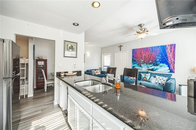 123 E Cora Lee Dr Unit 301, South Padre Island, TX 78597 - kitchen with a sink, extractor fan, freestanding refrigerator, white cabinets, and light wood-style floors