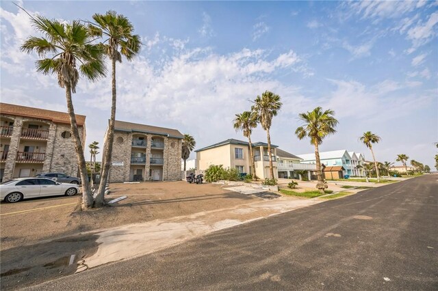 123 E Cora Lee Dr Unit 301, South Padre Island, TX 78597 - multi unit property featuring a residential view, uncovered parking, and stone siding