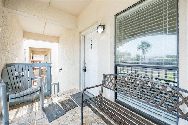 123 E Cora Lee Dr Unit 301, South Padre Island, TX 78597 - view of exterior entry with stucco siding and a porch