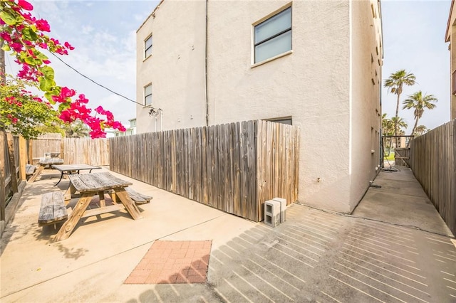 123 E Cora Lee Dr Unit 301, South Padre Island, TX 78597 - view of patio / terrace with outdoor dining space and a fenced backyard