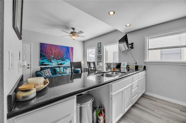 123 E Cora Lee Dr Unit 301, South Padre Island, TX 78597 - kitchen featuring a sink, white cabinetry, dark stone counters, a ceiling fan, and healthy amount of natural light