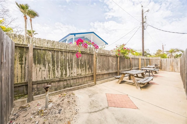 123 E Cora Lee Dr Unit 301, South Padre Island, TX 78597 - view of patio with a fenced backyard and outdoor dining area