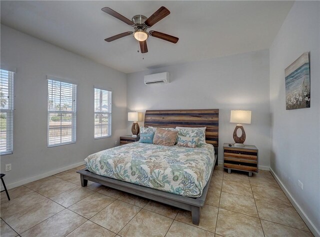 514 Royal Palm Dr, Port Aransas, TX 78373 - bedroom featuring a wall unit AC, tile patterned floors, baseboards, and a ceiling fan