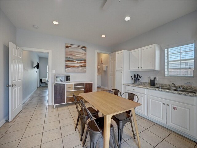514 Royal Palm Dr, Port Aransas, TX 78373 - kitchen featuring a sink, white cabinetry, light tile patterned floors, light stone countertops, and recessed lighting