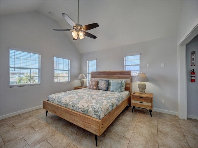 514 Royal Palm Dr, Port Aransas, TX 78373 - bedroom with high vaulted ceiling, baseboards, a ceiling fan, and light tile patterned floors