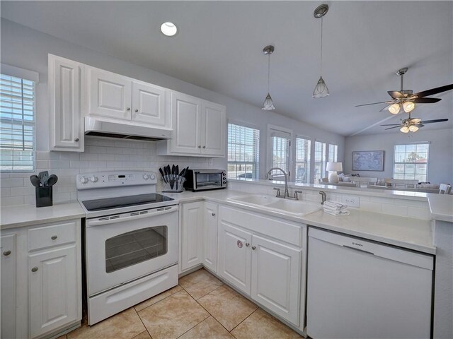 514 Royal Palm Dr, Port Aransas, TX 78373 - kitchen with white appliances, under cabinet range hood, a sink, tasteful backsplash, and light tile patterned floors