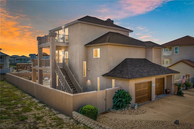 exterior space with a garage and a balcony