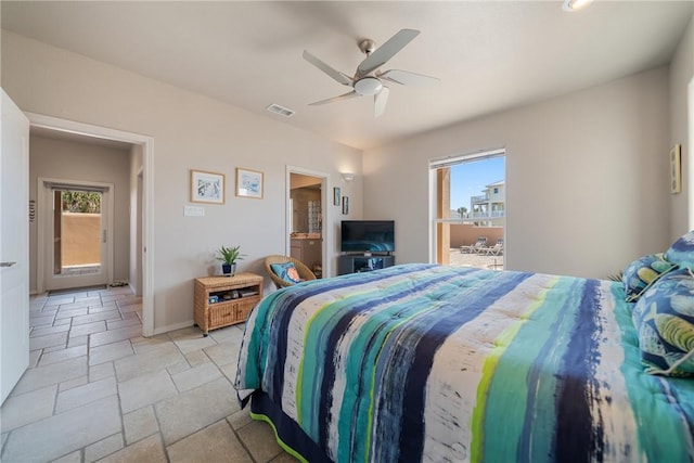 113 Sea Air Ln, Port Aransas, TX 78373 - bedroom featuring stone tile flooring, ceiling fan, and ensuite bath