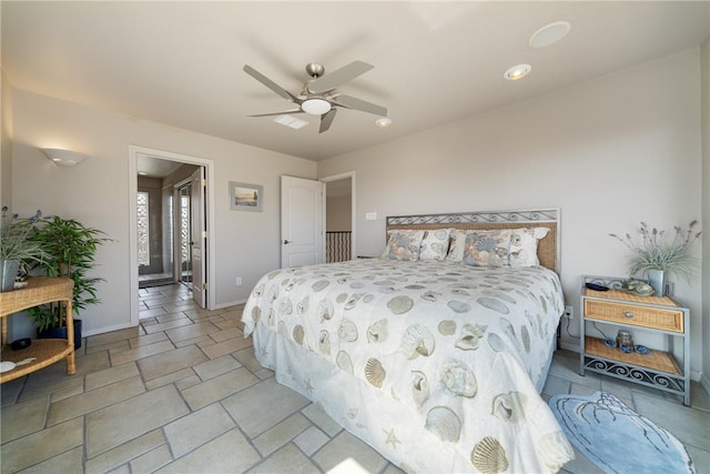 113 Sea Air Ln, Port Aransas, TX 78373 - bedroom featuring ceiling fan and light stone finish flooring
