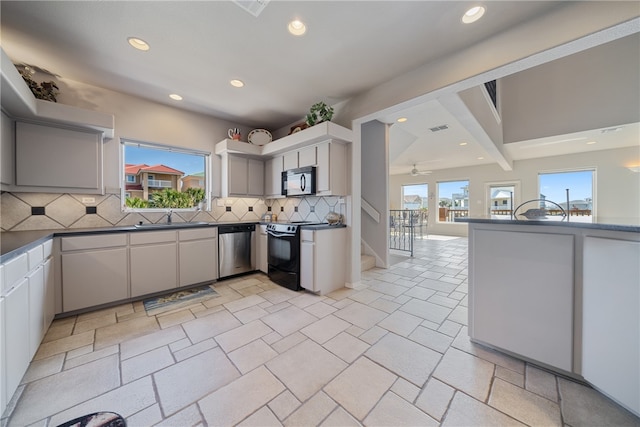 kitchen featuring white cabinetry, sink, black appliances, tasteful backsplash, and ceiling fan