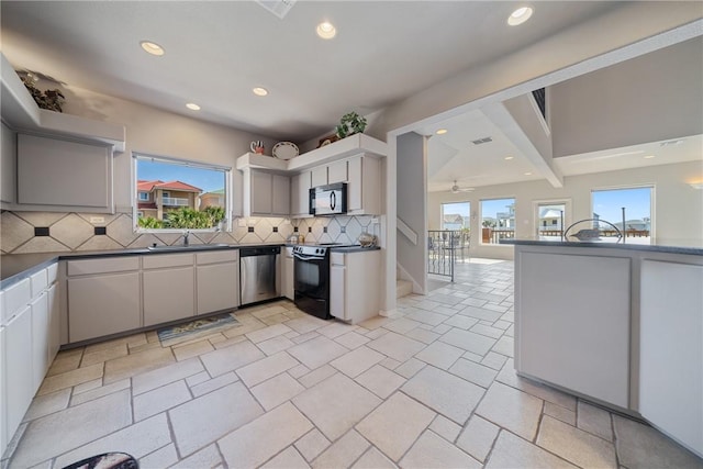 113 Sea Air Ln, Port Aransas, TX 78373 - kitchen with black appliances, recessed lighting, dark countertops, tasteful backsplash, and ceiling fan