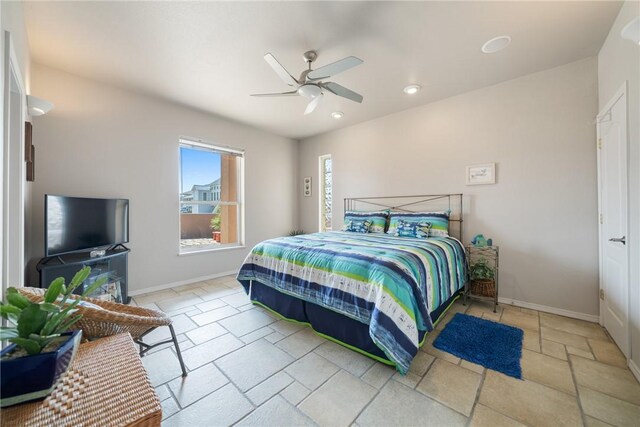 113 Sea Air Ln, Port Aransas, TX 78373 - bedroom with stone tile floors, recessed lighting, and a ceiling fan