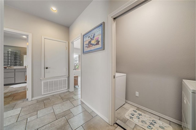 113 Sea Air Ln, Port Aransas, TX 78373 - laundry room featuring stone tile flooring, recessed lighting, and washer / clothes dryer