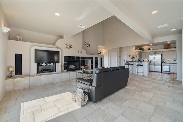 113 Sea Air Ln, Port Aransas, TX 78373 - living room with stone tile floors, vaulted ceiling, and recessed lighting