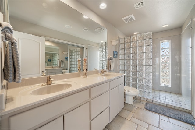 bathroom with walk in shower, vanity, and toilet