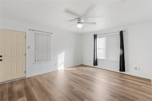 empty room featuring light hardwood / wood-style flooring and ceiling fan