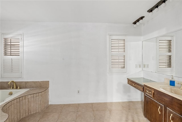 bathroom featuring vanity, tiled bath, and tile patterned floors