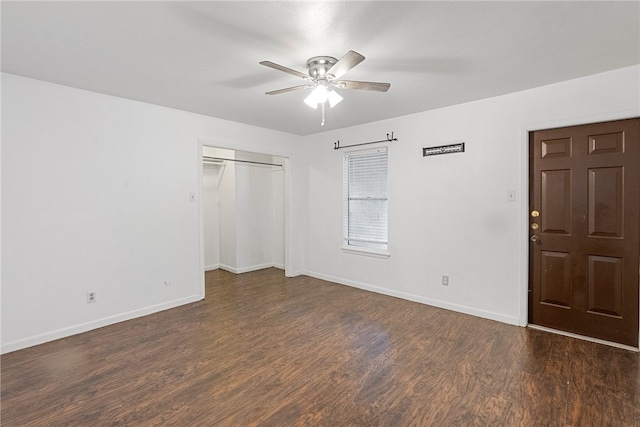 unfurnished bedroom with dark wood-type flooring, a closet, and ceiling fan