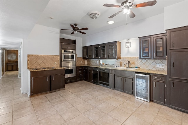 kitchen with tasteful backsplash, dark brown cabinetry, sink, beverage cooler, and double oven