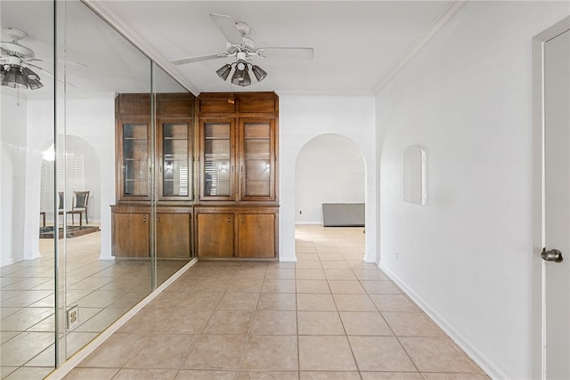 corridor with light tile patterned flooring and ornamental molding