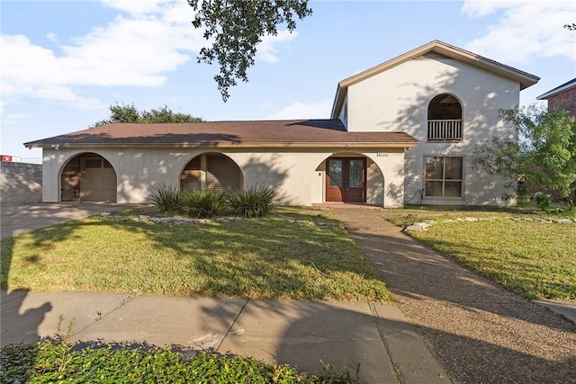 mediterranean / spanish-style house with a garage and a front yard