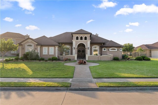 8401 Lago Vista Dr, Corpus Christi, TX 78414 - view of front of house with a front lawn, a chimney, and stucco siding