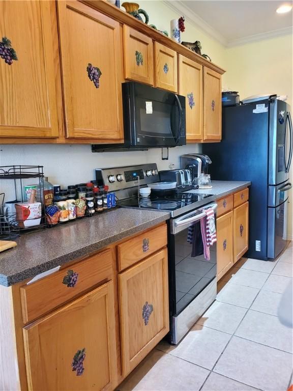 2602 Whirlwind St, Corpus Christi, TX 78414 - kitchen with stainless steel electric range, black microwave, light tile patterned floors, ornamental molding, and dark stone countertops