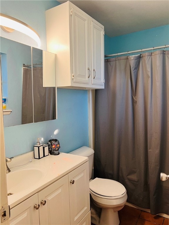 bathroom with toilet, vanity, a shower with shower curtain, and tile patterned flooring