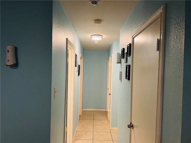 corridor featuring light tile patterned floors