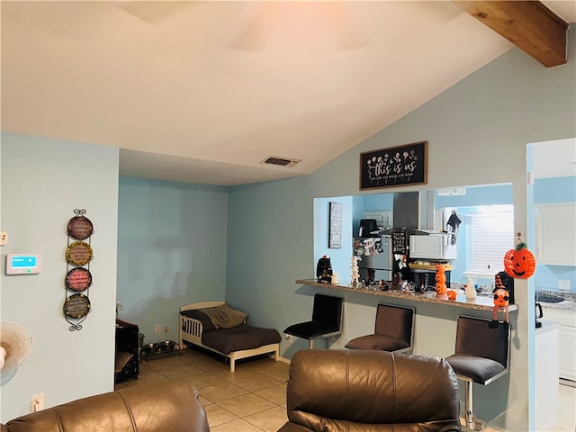 tiled living room with lofted ceiling with beams