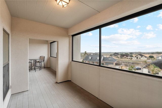 unfurnished sunroom featuring a residential view