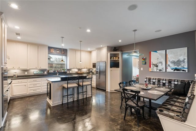 dining area with recessed lighting, visible vents, and concrete floors