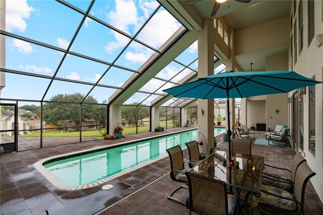 pool featuring outdoor dining space, a lanai, a ceiling fan, and a patio area