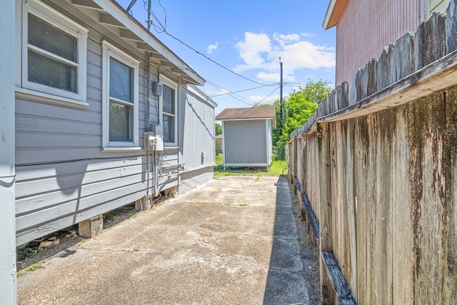 view of side of property with a storage unit