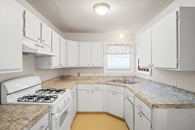 kitchen featuring sink, white cabinetry, a textured ceiling, and white gas range