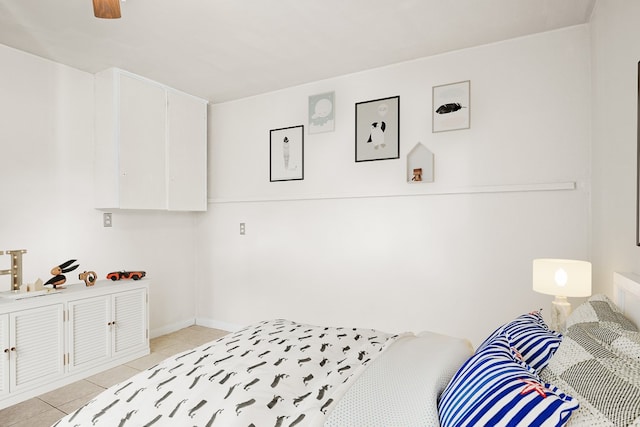 tiled bedroom featuring ceiling fan