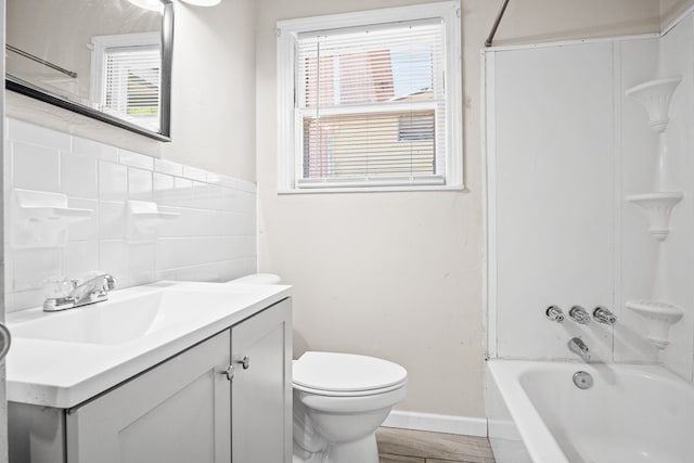 full bathroom featuring toilet, washtub / shower combination, and vanity