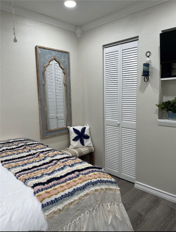 bedroom featuring dark wood-type flooring and ornamental molding