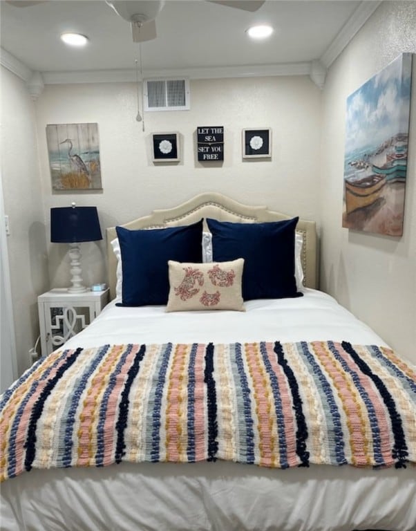 bedroom with ceiling fan and ornamental molding