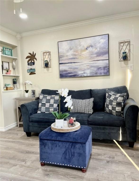 3938 Surfside Blvd Unit 1326, Corpus Christi, TX 78402 - living area with wood finished floors, crown molding, built in shelves, and baseboards