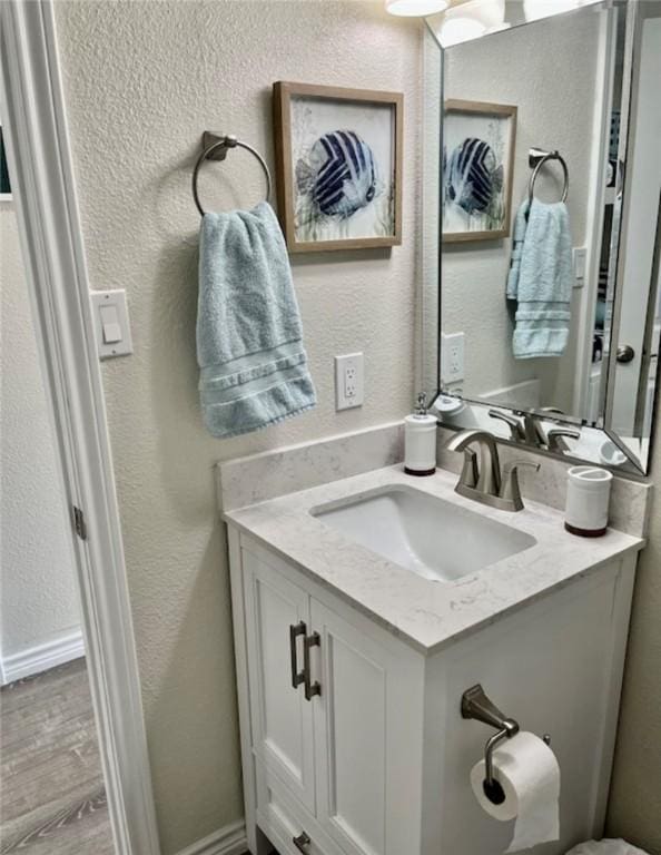 3938 Surfside Blvd Unit 1326, Corpus Christi, TX 78402 - bathroom with vanity, a textured wall, and wood finished floors