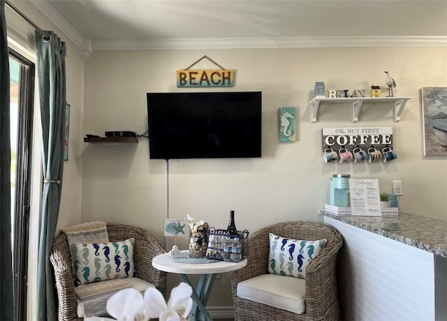 sitting room featuring crown molding