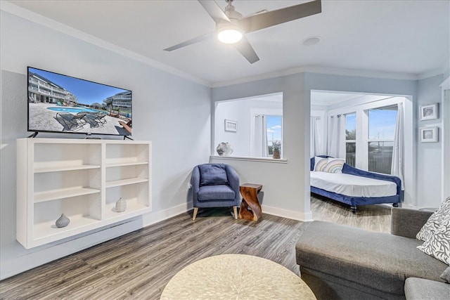 bedroom with hardwood / wood-style floors, ceiling fan, and ornamental molding