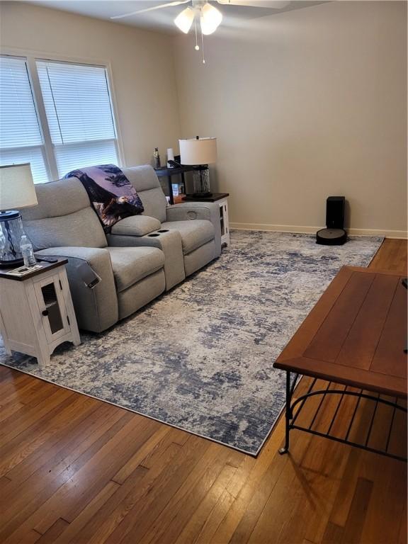 living room with ceiling fan and wood-type flooring