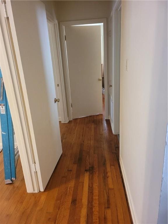 corridor with hardwood / wood-style floors